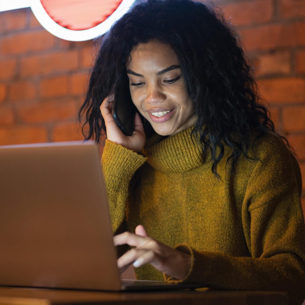 smiley woman talking phone coffee shop